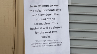 This Saturday, March 28 file photo shows a sign on a liquor store announcing it is closing to keep the neighborhood safe and slow down the COVID-19 coronavirus in Indianapolis.