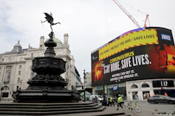 A video screen displays a message urging people to stay home, at Piccadilly Circus in London on Wednesday, April 8. The highly contagious COVID-19 coronavirus has impacted on nations around the globe, many imposing self isolation and exercising social distancing when people move from their homes.