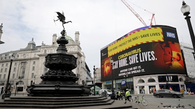 A video screen displays a message urging people to stay home, at Piccadilly Circus in London on Wednesday, April 8. The highly contagious COVID-19 coronavirus has impacted on nations around the globe, many imposing self isolation and exercising social distancing when people move from their homes.