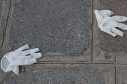 Plastic gloves lays on the ground in Paris on Friday, April 10,during a nationwide confinement to counter the new coronavirus.