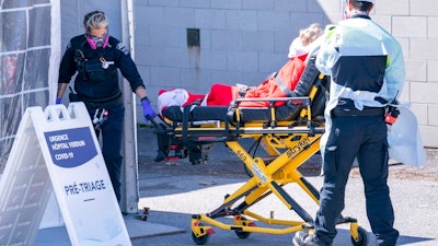 A patient is wheeled into the emergency unit of the Verdun Hospital in Montreal on Monday, April 6, 2020. Prime Minister Justin Trudeau says he’s confident Canada will still be able to import N95 protective masks form the U.S. despite an export ban and says he will talk to U.S. President Donald Trump in the coming days.