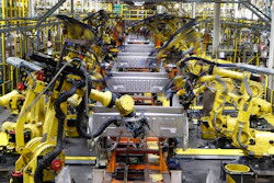 In this Sept. 27, 2018 file photo, robots weld the bed of a 2018 Ford F-150 truck on the assembly line at the Ford Rouge assembly plant in Dearborn, MI. US businesses are edging their way toward figuring out how to bring their employees back to work amid the coronavirus pandemic, some more gracefully than others. Detroit-area automakers, which suspended production in March, are now pushing to restart factories as soon as possible.