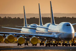 In this April 20, 2020 file photo, Lufthansa airline, Boeing 747 aircrafts are parked at the airport in Frankfurt, Germany. Boeing says it will cut about 10% of its work force and slow production of planes as it deals with the ongoing grounding of its best-selling plane and the coronavirus pandemic. With air travel falling sharply because of the virus, airlines have delayed orders and deliveries of new planes, reducing Boeing’s revenue.