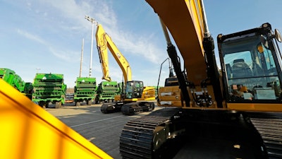 In this Nov. 4, 2019, file photo construction equipment made by Caterpillar are readied for export to Asia at the Port of Tacoma in Tacoma, Wash. Caterpillar Inc. reports financial results Friday, Jan. 31, 2020.