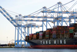 In this Nov. 4, 2019 file photo, cargo cranes are used to take containers off of a Yang Ming Marine Transport Corporation boat at the Port of Tacoma in Tacoma, WA.