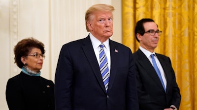 President Donald Trump, along with Jovita Carranza, administrator of the Small Business Administration, and Treasury Secretary Steven Mnuchin.