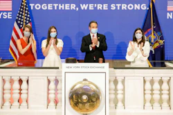 In this image provided by the New York Stock Exchange, New York State Gov. Andrew Cuomo, center, applauds as he rings the opening bell of the New York Stock Exchange with with New York Stock Exchange President Stacey Cunningham, right on Tuesday, May 26 in New York. The NYSE allowed a limited number of traders back to the floor with social distancing guidelines and face masks.