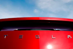 In this April 15, 2018 file photo, the sun shines off the rear deck of a roadster on a Tesla dealer's lot in the south Denver suburb of Littleton, Colo. Tesla has picked Austin, Texas, and Tulsa, Oklahoma, as finalists for its new U.S. assembly plant, a person briefed on the matter said Friday, May 15, 2020.