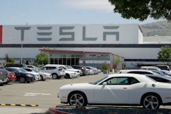 Vehicles are seen parked at the Tesla car plant Monday, May 11, 2020, in Fremont, Calif. The parking lot was nearly full at Tesla's California electric car factory Monday, an indication that the company could be resuming production in defiance of an order from county health authorities.