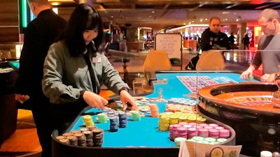A dealer handling stacks of chips on a roulette table at the Tropicana Casino and Resort in Atlantic City, N.J., April 17, 2015.