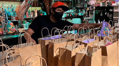 This photo provided by Lei Low Bar shows David Perez, organizing To-go orders at the Lei Low Bar in Houston on June 25.