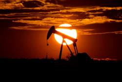 In this Wednesday, April 8, 2020, file photo, the sun sets behind an idle pump jack near Karnes City, Texas.