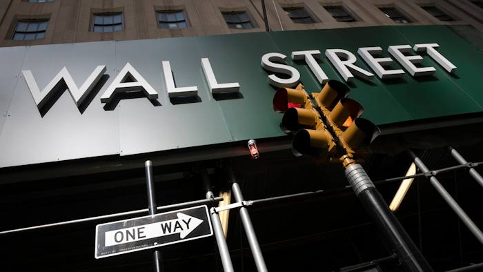 In this June 16 photo, a sign for a Wall Street building is shown in New York. Earnings reporting season is about to get underway for big companies, and the forecasts are grim. Wall Street expects S&P 500 companies to report profits plunged by the most since the depths of the Great Recession during the second quarter.