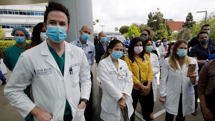 Hospital personnel stand outside Providence St. John's Medical Center in Santa Monica, Calif.