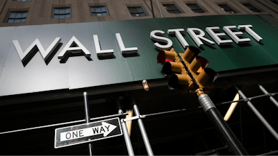 In this June 16 photo, a sign for a Wall Street building is shown in New York. Earnings reporting season is about to get underway for big companies, and the forecasts are grim. Wall Street expects S&P 500 companies to report profits plunged by the most since the depths of the Great Recession during the second quarter.