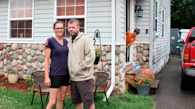 Crystal and Chris Martin stand outside their home, Sunday, July 19, 2020 in Burton, Mich.