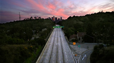 This April 26, 2020, photo shows empty lanes of the 110 Arroyo Seco Parkway that leads to downtown Los Angeles during the coronavirus outbreak in Los Angeles, CA. A record drop in U.S. energy consumption this spring was driven by less demand for coal that's burned for electricity and oil that's refined into gasoline and jet fuel.
