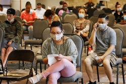 People wait to speak with representatives from the Oklahoma Employment Security Commission about unemployment claims on July 9 in Midwest City, OK.