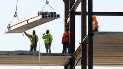 In this Dec. 3, 2019 file photo, workers erect a building under construction in Philadelphia.