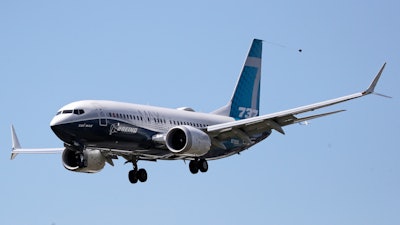 A Boeing 737 MAX jet heads to a landing at Boeing Field following a test flight in a June 29, 2020 photo in Seattle. Boeing is reporting more weak numbers for airplane orders and deliveries. The big aircraft maker said Tuesday, Aug. 11, 2020 it it sold no new airliners in July, and customers canceled orders for 43 of its 737 Max jet.
