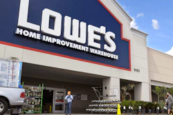 In this March 22 file photo, customers wearing masks walk into a Lowe's home improvement store in the Canoga Park section of Los Angeles.