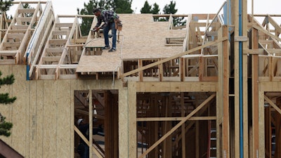 Workers toil on a multifamily dwelling on Aug. 4 in Winter Park, CO.