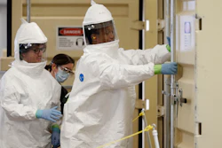 In Colorado, where there is a shortage of PPE, workers prepare to enter an N95 mask-cleaning machine.