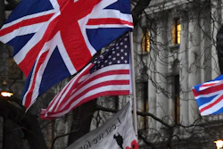 In this file photo dated Friday, Jan. 31, 2020, Brexit supporters hold British and US flags during a rally in London.