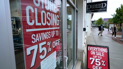 Storefront with store closing and sale signs in Dedham, Mass., Sept. 2, 2020.
