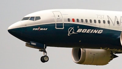 In this Sept. 30, 2020, file photo, a Boeing 737 MAX jet, piloted by Federal Aviation Administration (FAA) chief Steve Dickson, prepares to land at Boeing Field following a test flight in Seattle. Boeing says the pandemic will reduce demand for new planes for the next decade, long after experts expect a vaccine for COVID-19. The company updated its forecast of the airplane market on Tuesday, Oct. 6, 2020. It remains upbeat about long-term prospects driven by increasing air travel in Asia. Boeing, which along with Europe’s Airbus dominates the aircraft-building industry, has seen orders and deliveries of new planes crumble this year.