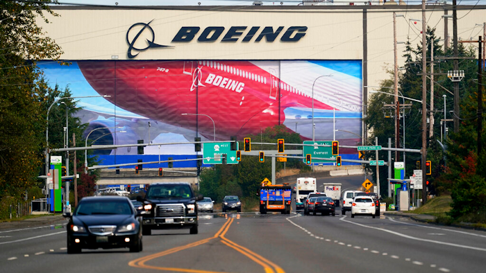Traffic passes the Boeing airplane production plant, in Everett, Wash.