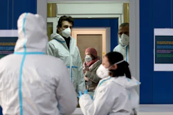 A medical workers works in a COVID-19 set up for rapid new coronavirus testing in Vienna, Austria on Monday, Nov. 30.