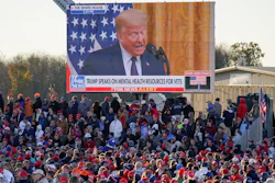 A throng of supporters listen to a video message as they await President Donald Trump for a campaign stop, Saturday, Oct. 31 at the Butler County Regional Airport in Butler, PA.