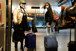 Travelers leave the AirTrain at JKF International Airport on Nov. 20 in New York.