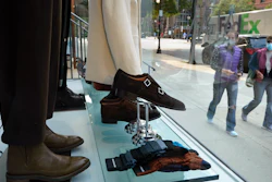 Storefront window in the Newbury Street shopping district, Boston, Sept. 15, 2020.