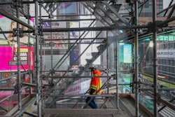 A construction worker walks down a staircase in the scaffolding of TSX Broadway under construction on Oct. 29 in New York's Times Square.