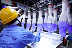 A worker inspects disposable gloves at the Top Glove factory in Shah Alam on the outskirts of Kuala Lumpur, Malaysia.