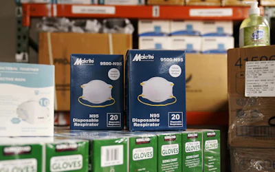 Personal protective masks are displayed on a pallet of protective gloves in the warehouse at the Body Armor Outlet store on Dec. 9 in Salem, N.
