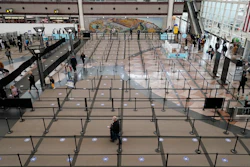 Travelers head through the south security checkpoint check in the terminal of Denver International Airport on Dec. 10 in Denver.