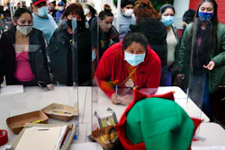 People check in at a food bank held at Los Angeles Boys & Girls Club, Lincoln Heights, Los Angeles, Dec. 17, 2020.