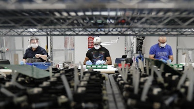 Ford Motor Co. line workers put together ventilators at the Ford Rawsonville plant, Ypsilanti Township, Mich., May 13, 2020.