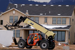 In this Dec. 1, 2020 file photo, workers toil on new homes under construction in a development near Chatfield State Park in Littleton, CO.