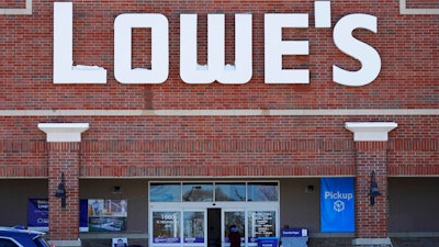 A customer covers his face as he walks to a Lowe's home- improvement store in Vernon Hills, IL on Feb. 3.