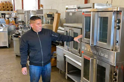 Jose Bonilla Jr. shows a used industrial oven for sale in the warehouse of his family's business, American Restaurant Supply in San Leandro, CA on Jan. 14.