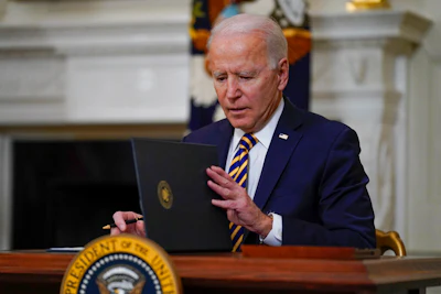 President Joe Biden closes the folder after signing an executive order relating to U.S. supply chains in the State Dining Room of the White House on Wednesday, Feb. 24 in Washington.