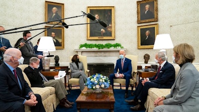 President Joe Biden speaks during a meeting with lawmakers on investments in infrastructure, in the Oval Office of the White House, Thursday, Feb. 11, 2021, in Washington. From left, Sen. Ben Cardin, D-Md., Sen. Jim Inhofe, R-Okla., Vice President Kamala Harris, Biden, Sen. Tom Carper, D-Del., and Sen. Shelley Moore Capito, R-W.Va.