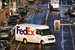 In this Dec. 29, 2020 photo, a FedEx delivery vehicle makes a U-turn near the Denver Pavilions, in downtown Denver.