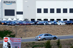 This Feb. 9, 2021 photo file photo, a car enters an Amazon facility where labor is trying to organize workers in Bessemer, Ala. Organizers are pushing for some 6,000 Amazon workers to join the Retail, Wholesale and Department Store Union on the promise it will lead to better working conditions, better pay and more respect. Amazon is pushing back, arguing that it already offers more than twice the minimum wage in Alabama and workers get such benefits as health care, vision and dental insurance without paying union dues.