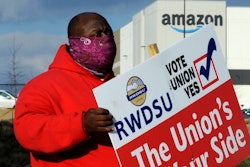 In this file photo, Michael Foster of the Retail, Wholesale and Department Store Union holds a sign outside an Amazon facility in Bessemer, Alabama.
