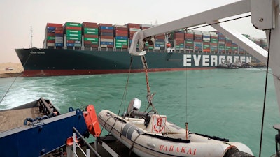 This photo released by the Suez Canal Authority shows the Ever Given, a Panama-flagged cargo ship, after it become wedged across the Suez Canal and blocking traffic.